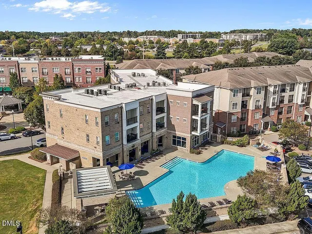 a view of swimming pool with outdoor seating and yard in back