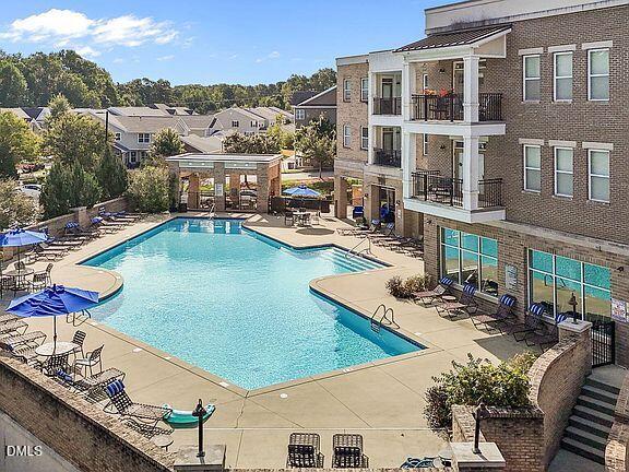 2021 Hayes Lane Holly Springs, NC 27540 - Photo 22 of 25 a view of a swimming pool with lounge chairs