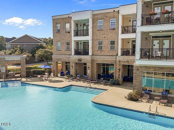 2021 Hayes Lane Holly Springs, NC 27540 - Photo 23 of 25 a view of a house with swimming pool and sitting area