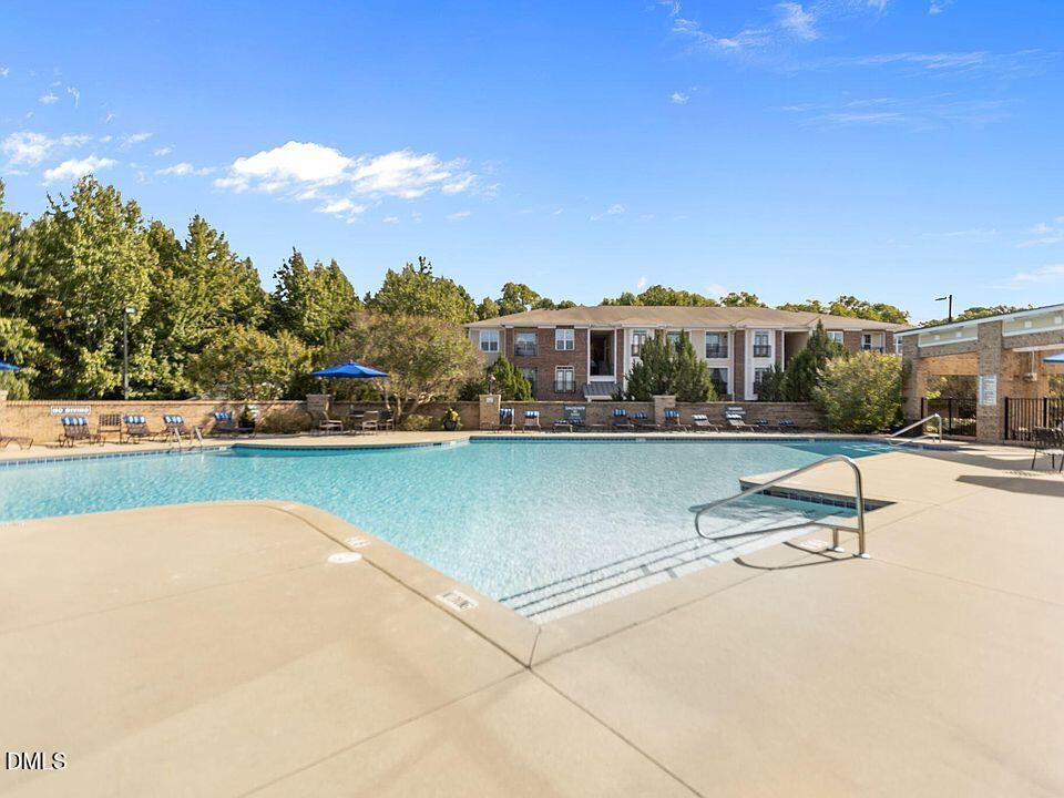 2021 Hayes Lane Holly Springs, NC 27540 - Photo 24 of 25 a view of swimming pool with outdoor seating and yard in back