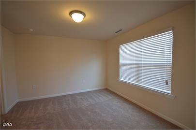 2021 Hayes Lane Holly Springs, NC 27540 - Photo 9 of 25 an empty room with a window