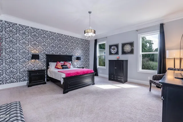 a spacious bedroom with a bed and a chandelier
