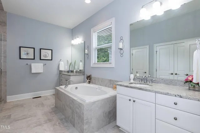 a front view of a house with a large window and wooden fence