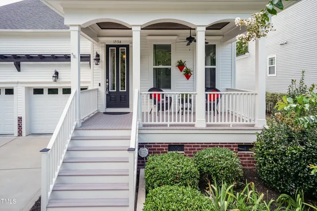 a view of a porch with furniture and garden
