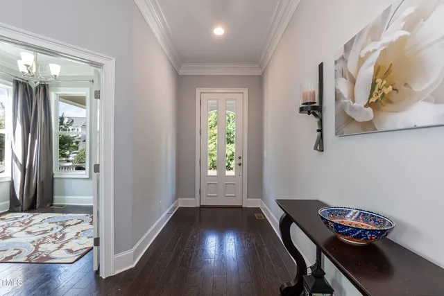 a living room with furniture a flat screen tv and a potted plant