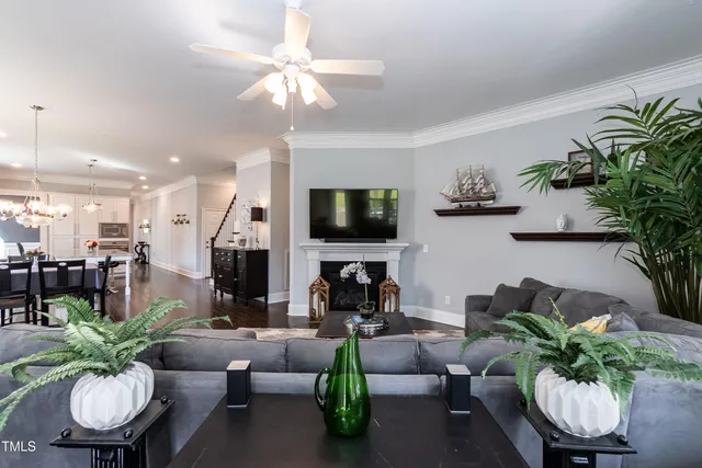 a kitchen with stainless steel appliances granite countertop a table chairs refrigerator and sink