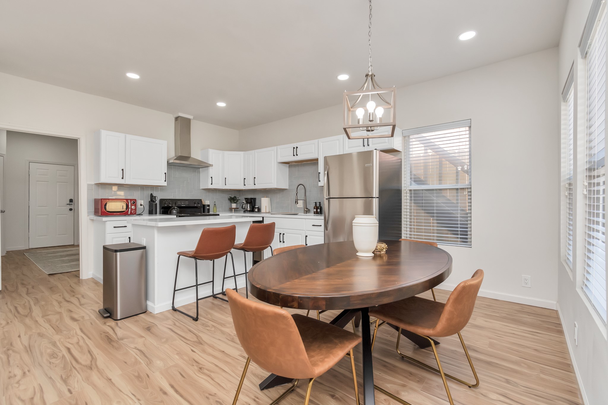 1812 Wheeler Avenue Houston, TX 77004 - Photo 11 of 34 a kitchen with stainless steel appliances kitchen island granite countertop a dining table chairs and a refrigerator