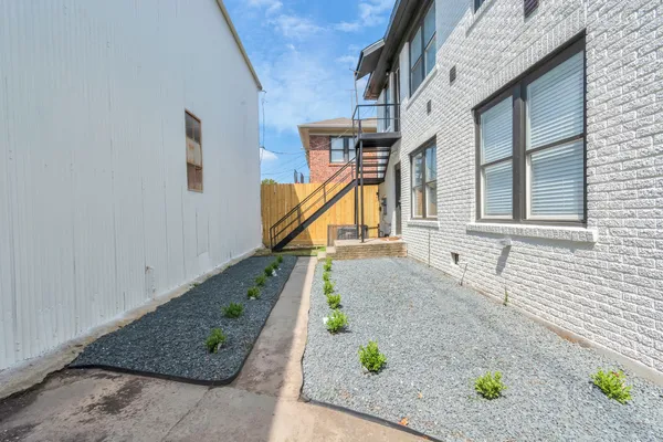 a kitchen with stainless steel appliances a sink a stove a refrigerator and cabinets