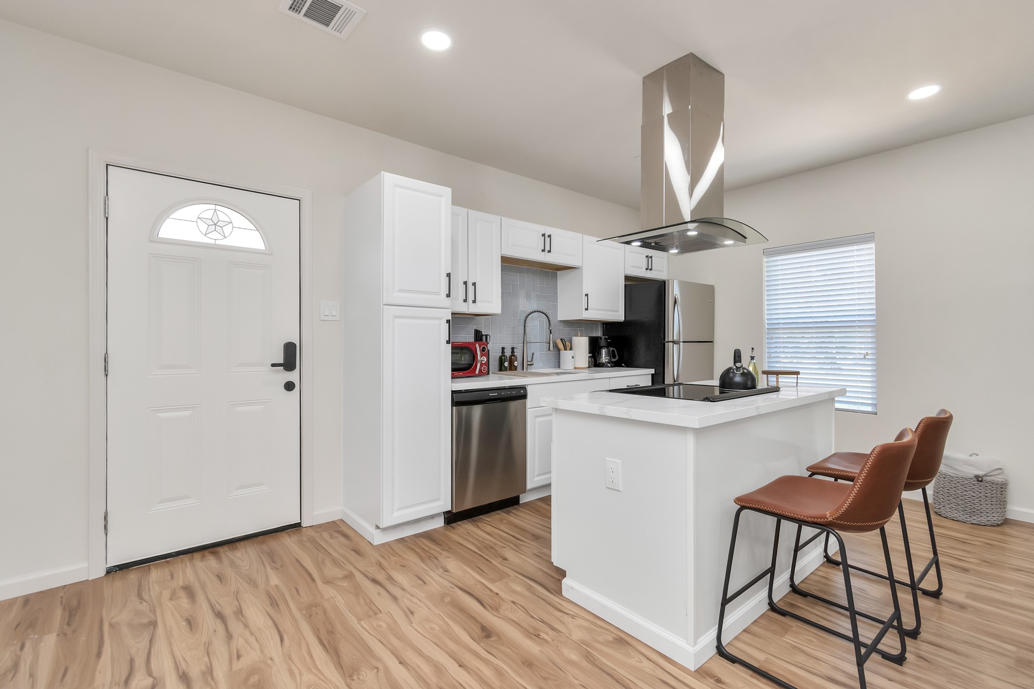 1812 Wheeler Avenue Houston, TX 77004 - Photo 22 of 34 a kitchen with kitchen island a sink cabinets and wooden floor