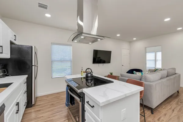 a living room with furniture and kitchen view
