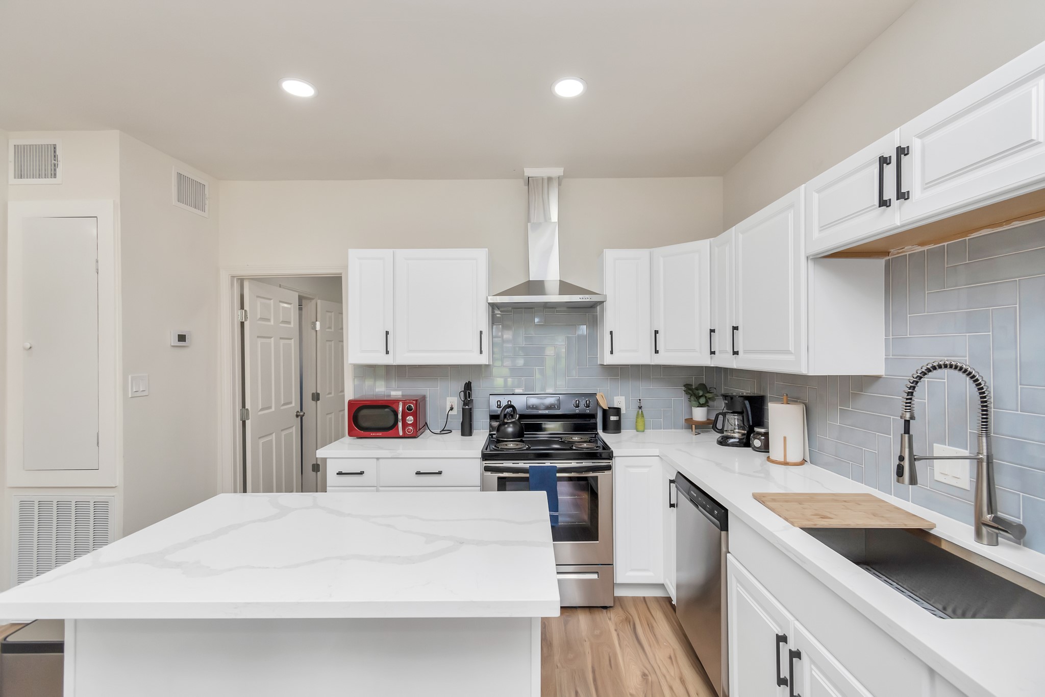 1812 Wheeler Avenue Houston, TX 77004 - Photo 9 of 34 a kitchen with a sink white cabinets and appliances