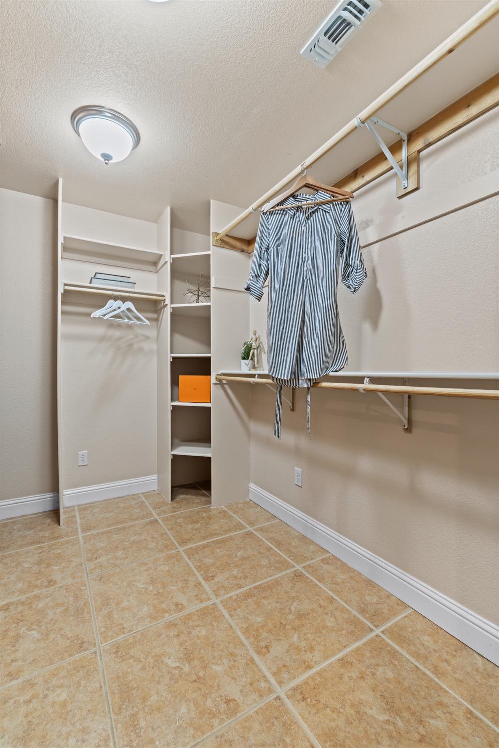 7396 Callison Road Penryn, CA 95663 - Photo 46 of 99 Walk-in closet in the primary suite with cherrywood cabinet built in.