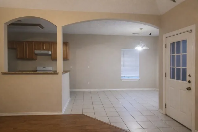 a view of a kitchen cabinets and a kitchen area with wooden floor