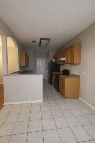 a kitchen with stainless steel appliances a refrigerator sink and microwave