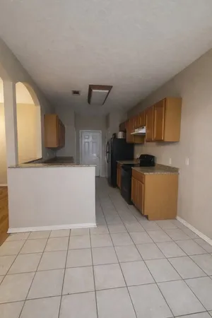 a kitchen with stainless steel appliances a refrigerator sink and microwave