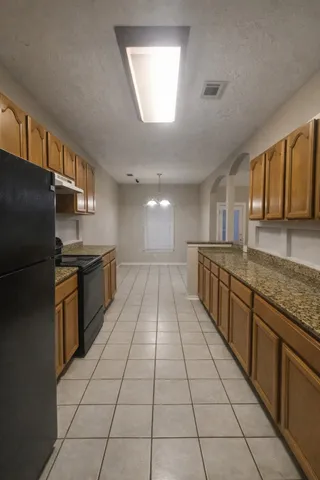 a large kitchen with granite countertop lots of counter space and window