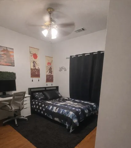 a bedroom with a bed and a chandelier