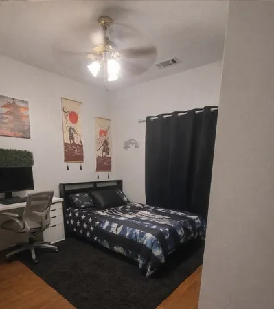 a bedroom with a bed and a chandelier