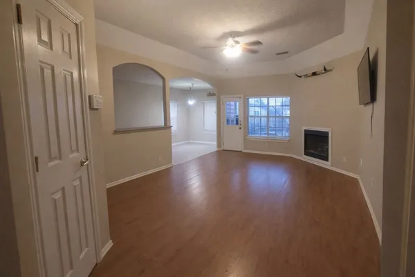 a view of a livingroom with wooden floor and window