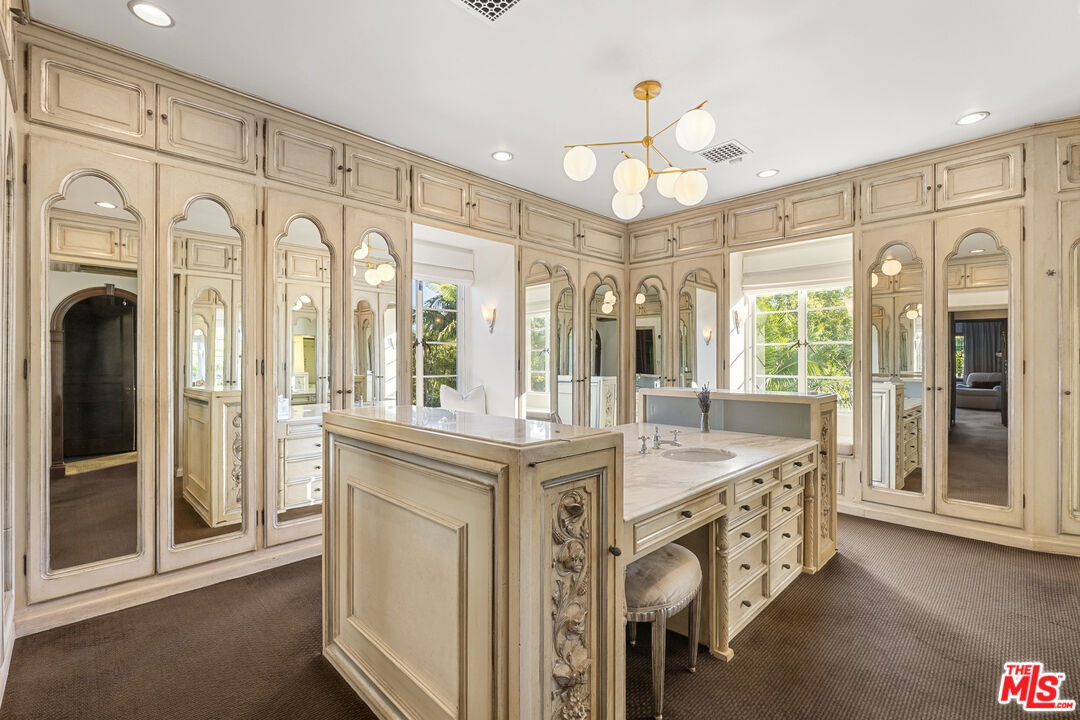 710 North Maple Drive Beverly Hills, CA 90210 - Photo 12 of 18 a very nice looking dining room with kitchen island granite countertop a fireplace and a large window