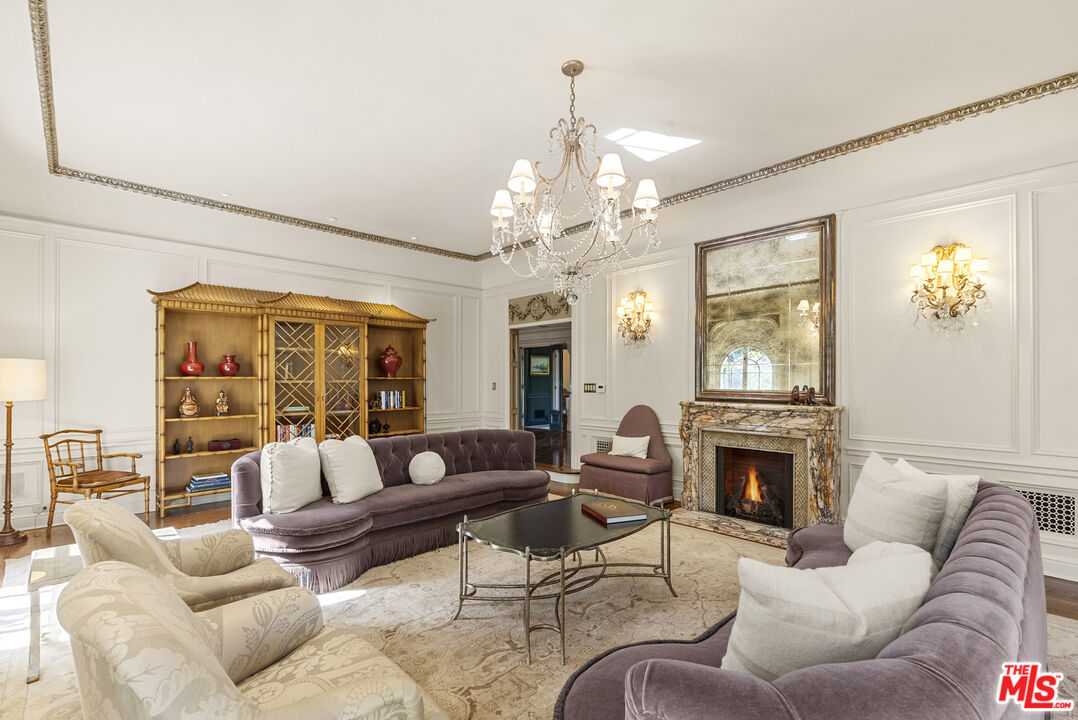 710 North Maple Drive Beverly Hills, CA 90210 - Photo 5 of 18 a living room with furniture fireplace and a large window