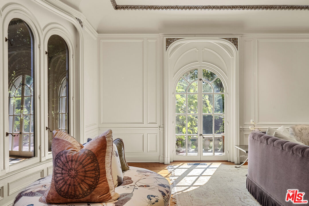 710 North Maple Drive Beverly Hills, CA 90210 - Photo 6 of 18 a living room with furniture and a large window