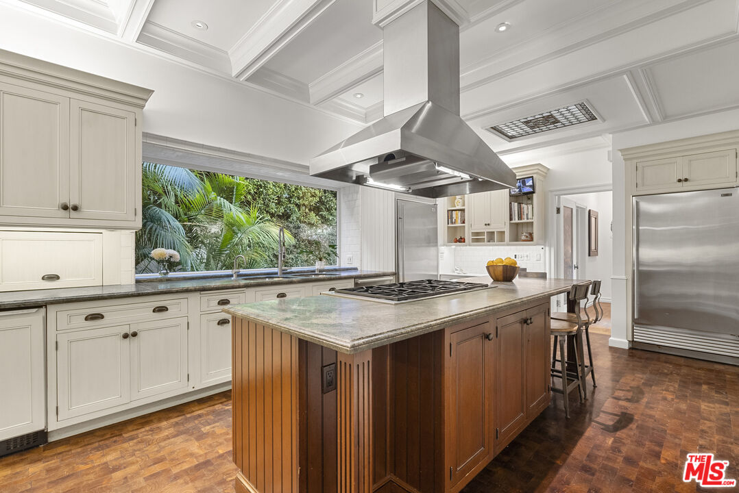 710 North Maple Drive Beverly Hills, CA 90210 - Photo 10 of 18 a kitchen with stainless steel appliances granite countertop a stove a sink and a refrigerator