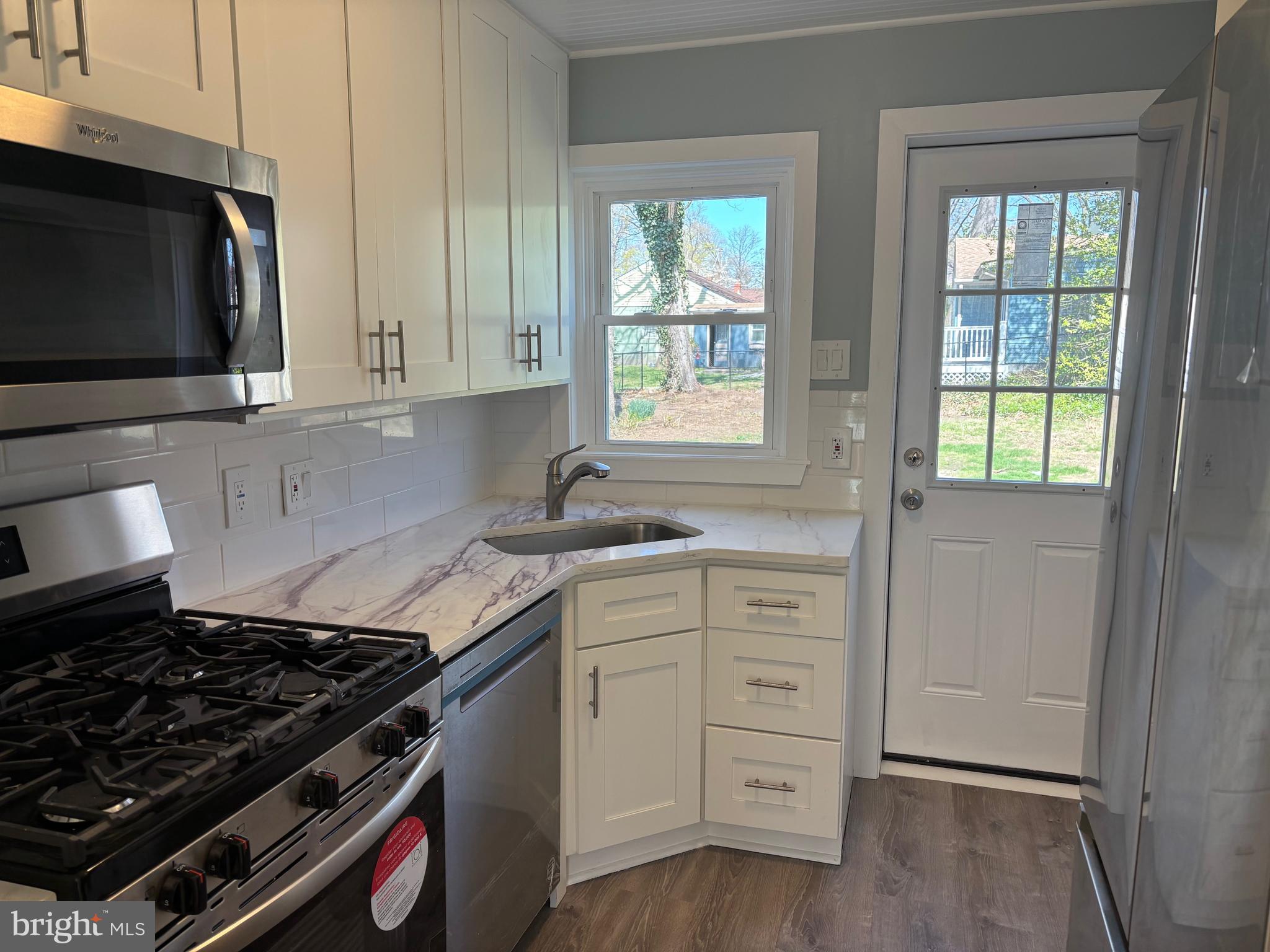 616 Chestnut Street Palmyra, NJ 08065 - Photo 5 of 10 a kitchen with white cabinets and appliances