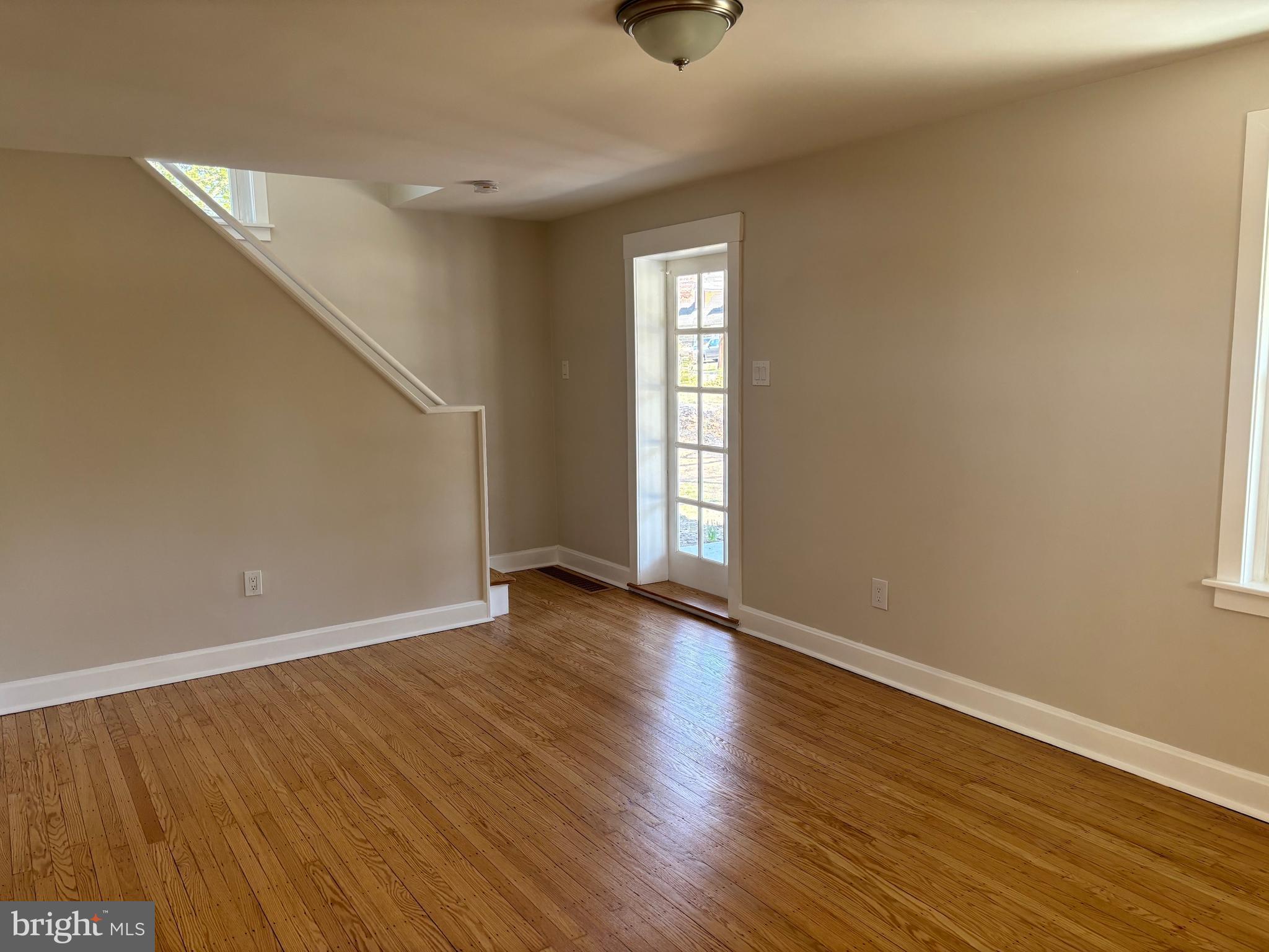 616 Chestnut Street Palmyra, NJ 08065 - Photo 7 of 10 a view of an empty room with wooden floor and a window