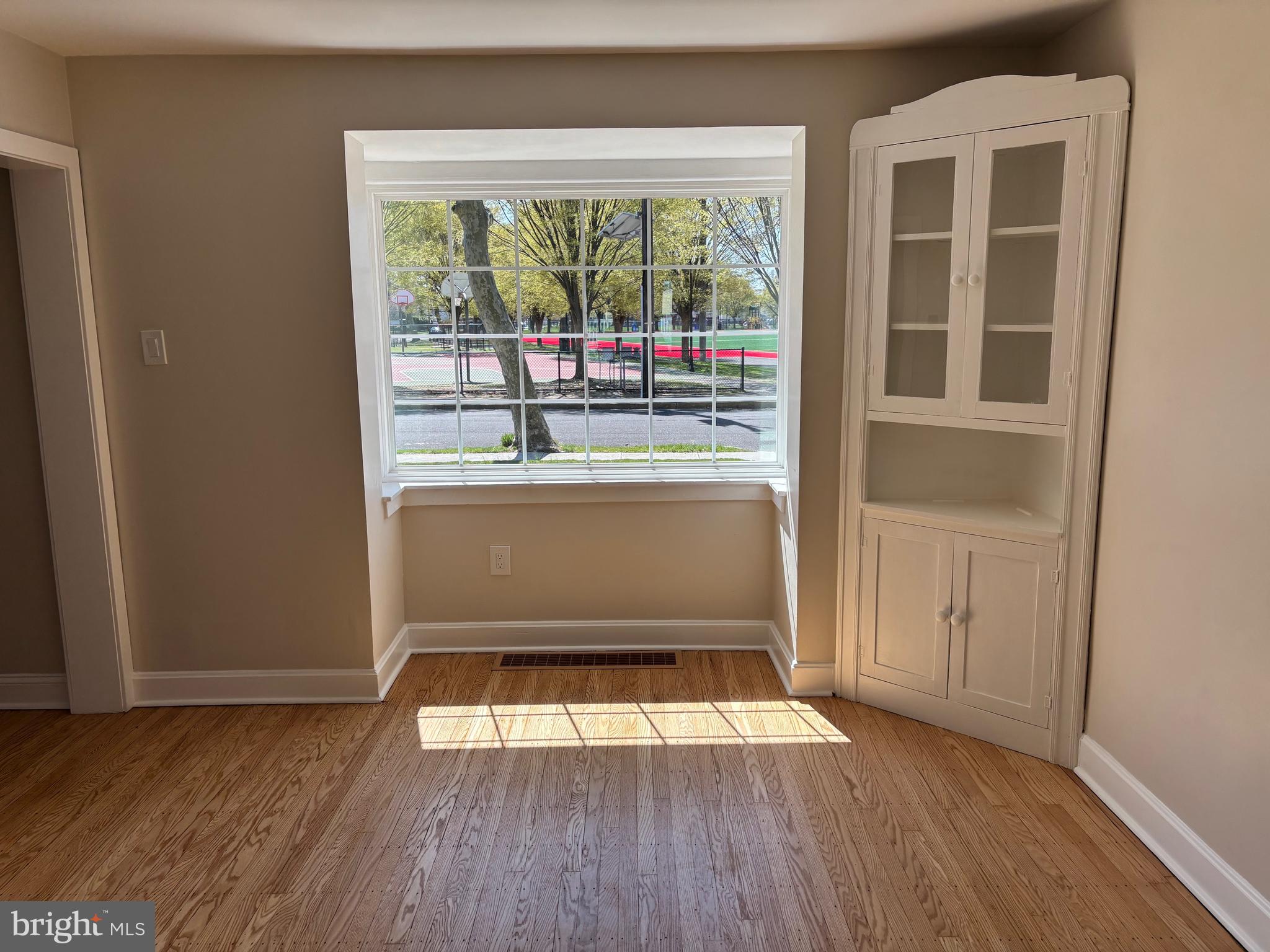 616 Chestnut Street Palmyra, NJ 08065 - Photo 9 of 10 an empty room with wooden floor and windows