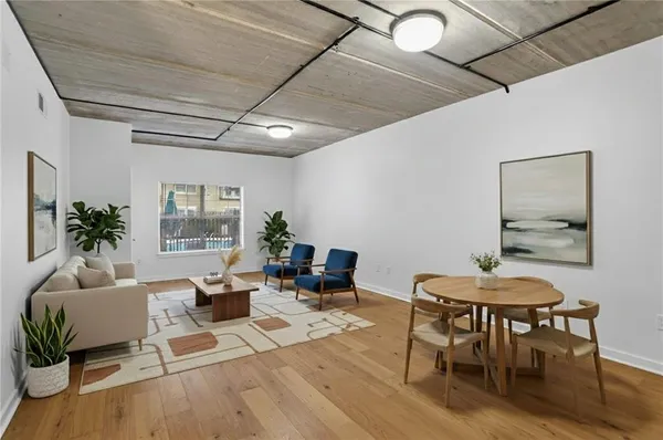 a living room with furniture and wooden floor