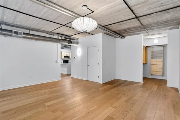 a view of empty room with wooden floor