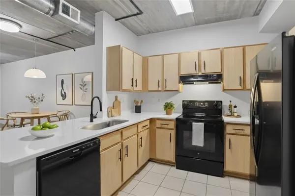a kitchen with a sink appliances and cabinets