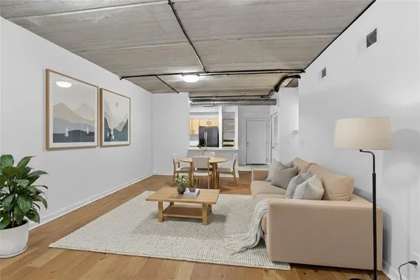 a living room with furniture and a potted plant