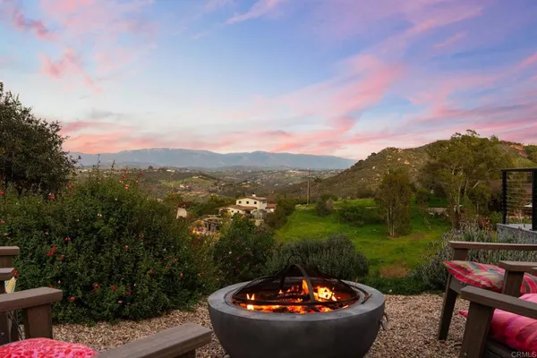 an aerial view of residential houses with outdoor space and mountain view