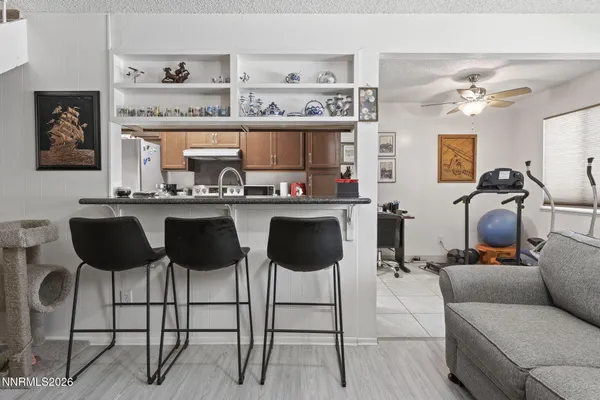 a kitchen with a dining table chairs and white cabinets