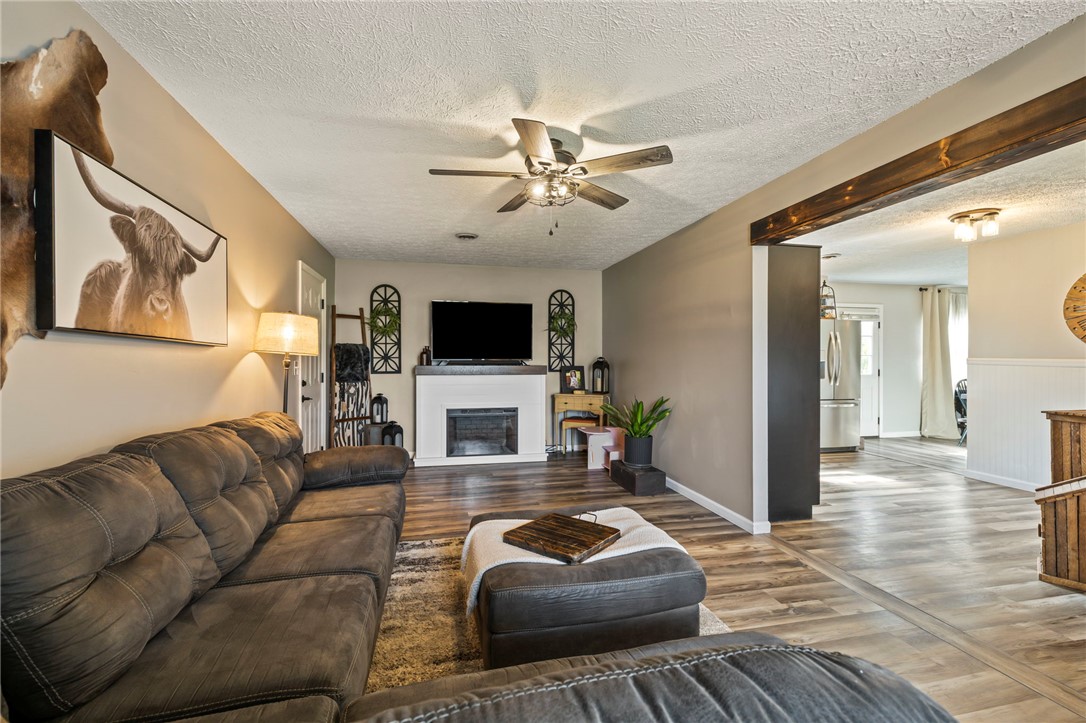 8969 Franklin-Trenton Road Franklin, OH 45005 - Photo 29 of 49 This living area features a warm fireplace and seamless flow into adjacent spaces.