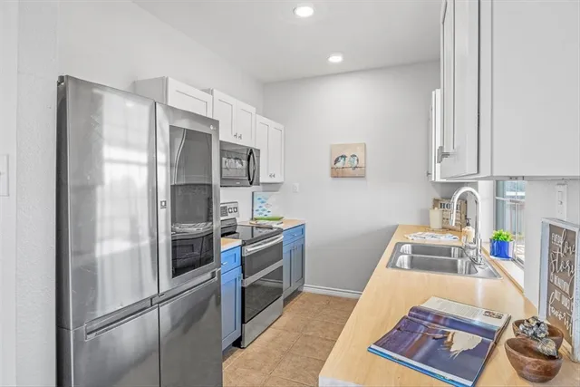a kitchen with a refrigerator and a sink