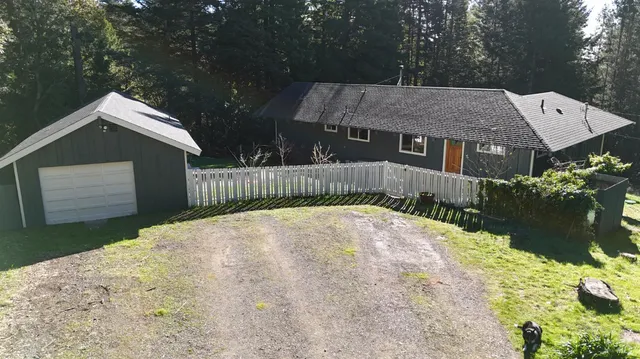 a bedroom with a bed and two windows
