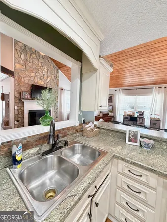 a kitchen with granite countertop a sink and a counter top space
