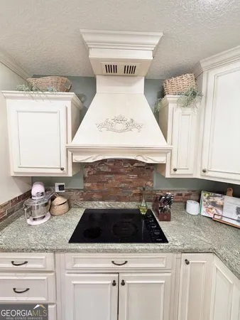 a white stove top oven sitting inside of a kitchen