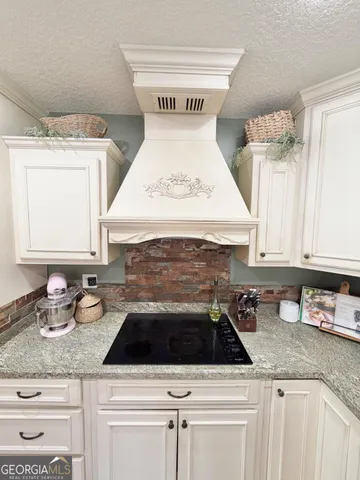 a white stove top oven sitting inside of a kitchen