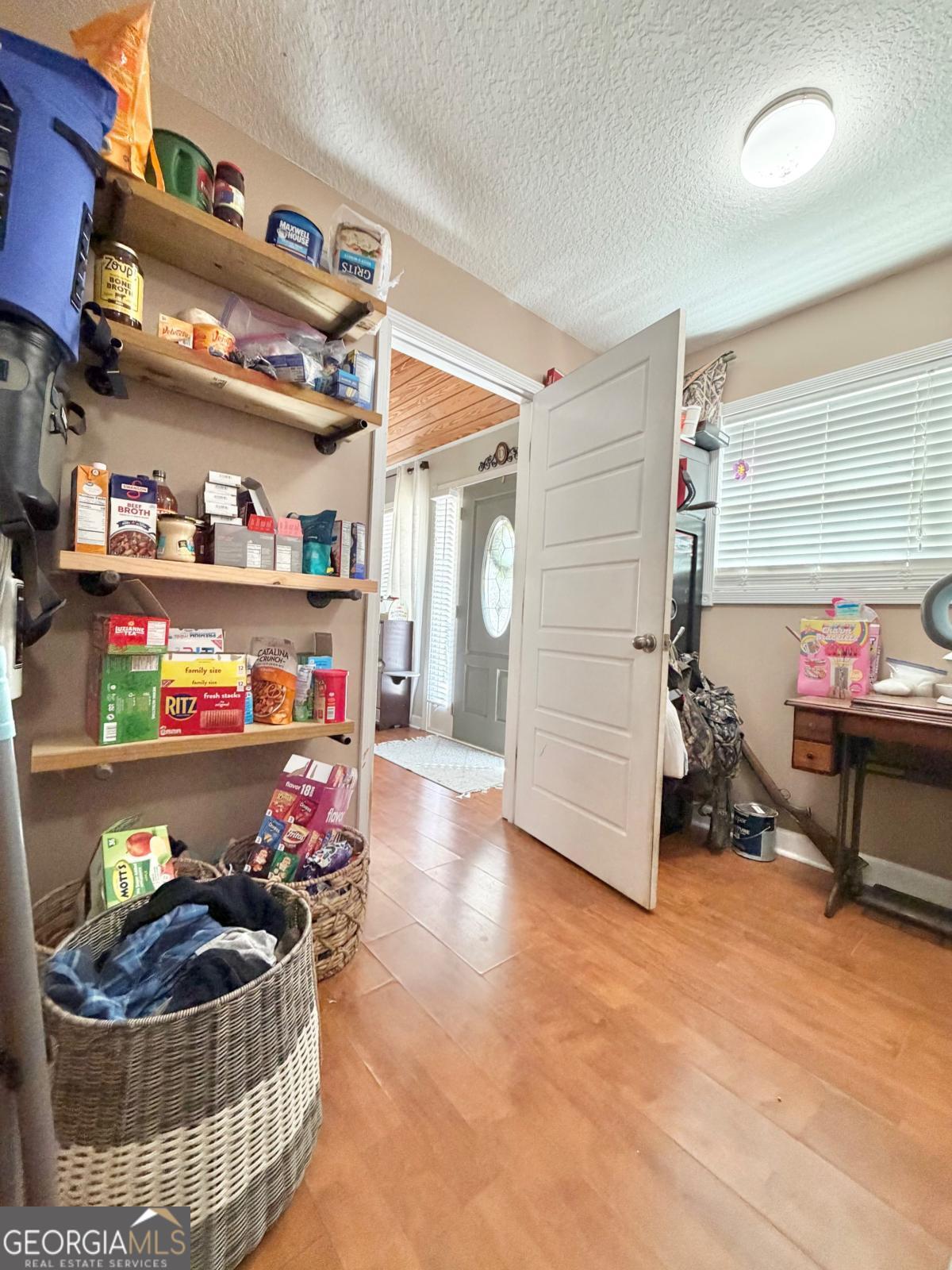3231 Pear Avenue Patterson, GA 31557 - Photo 17 of 43 a room with lots of white furniture and a wooden floor
