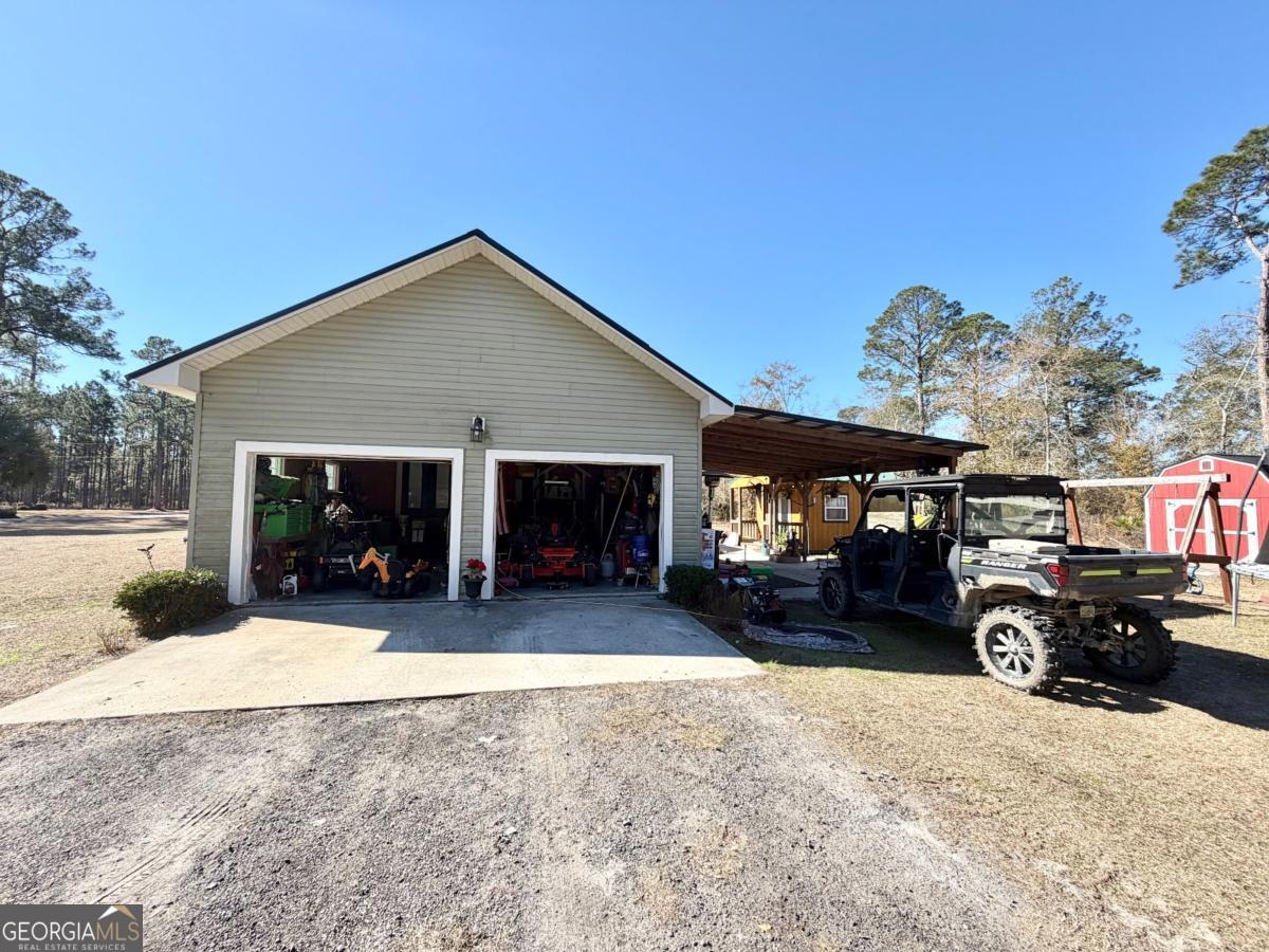 3231 Pear Avenue Patterson, GA 31557 - Photo 2 of 43 a view of a house with a snow in the yard