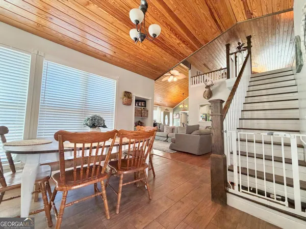 a view of a patio with table and chairs and wooden floor