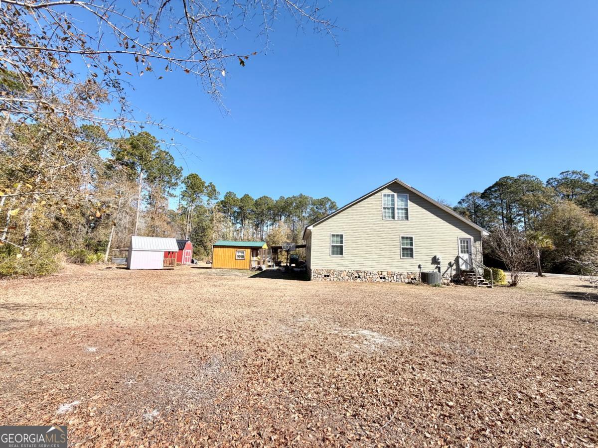 3231 Pear Avenue Patterson, GA 31557 - Photo 29 of 43 a view of a house with a yard