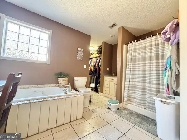 a kitchen with a sink and chairs