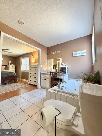 a bathroom with a toilet tub and sink
