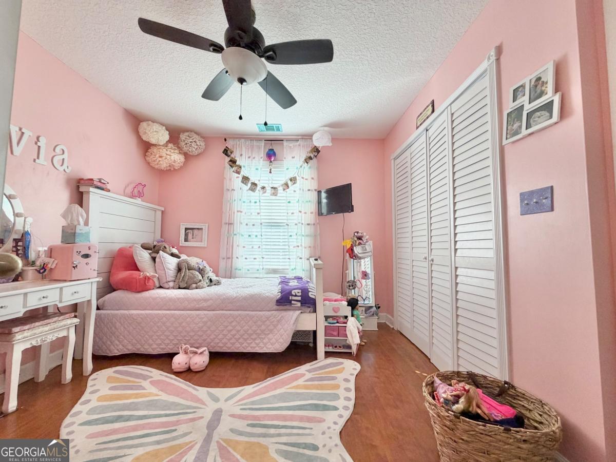 3231 Pear Avenue Patterson, GA 31557 - Photo 37 of 43 a bedroom with a bed chandelier and a window