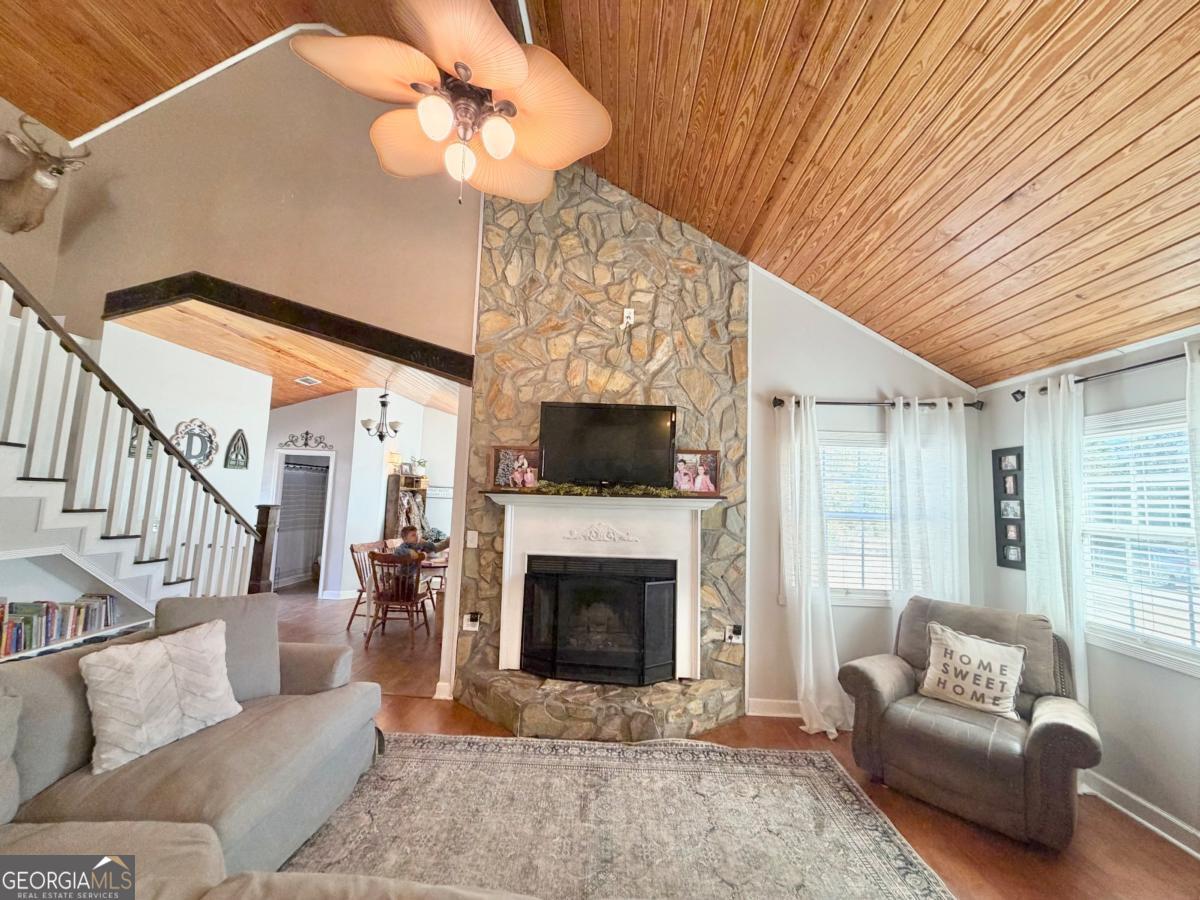 3231 Pear Avenue Patterson, GA 31557 - Photo 6 of 43 a living room with furniture a fireplace and a ceiling fan